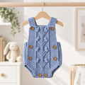 Blue crochet newborn dungaree romper with button straps and textured front