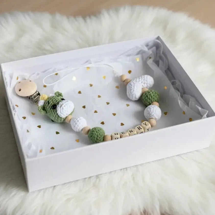 Crochet bear dummy clip with green bead accents and white name wooden blocks