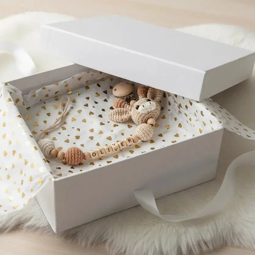 Crochet dummy clip garland with knit animal beads in neutral tan and cream