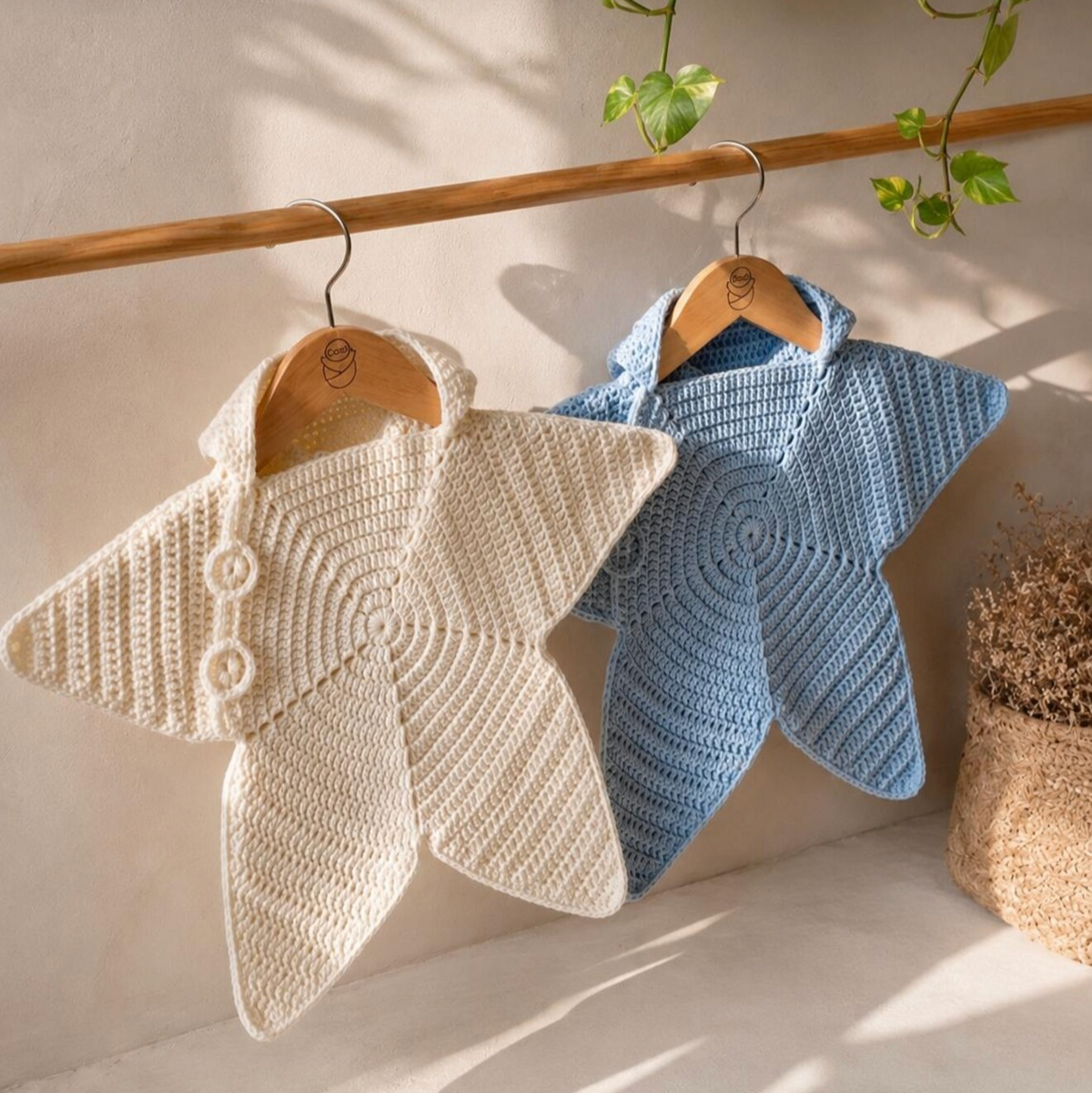 Cream and light blue crochet star baby ponchos with hood, shown side-by-side