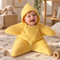 Yellow crochet star baby poncho with hood, worn by a smiling infant
