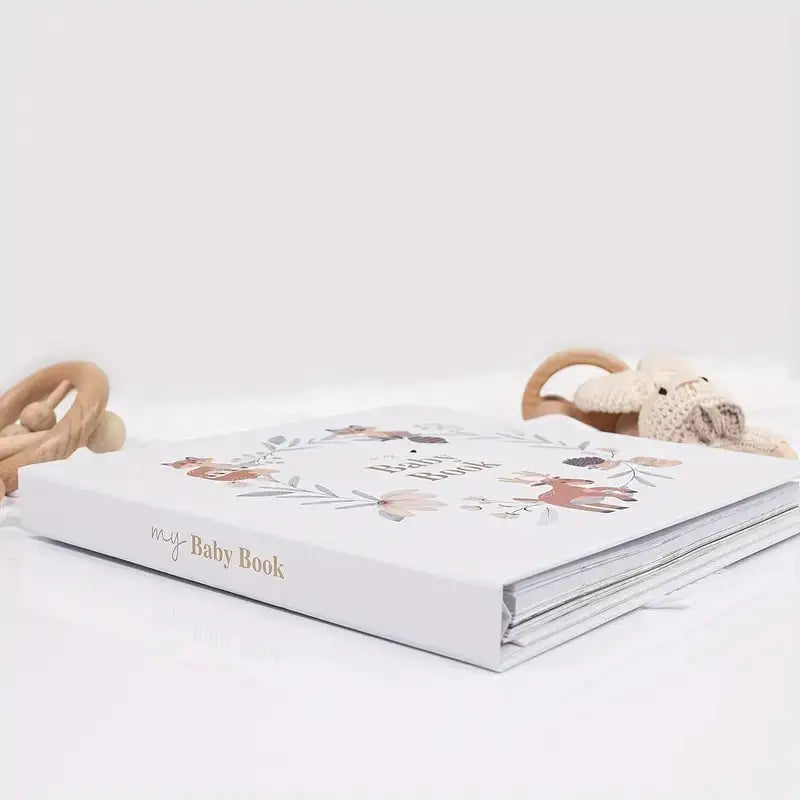 Baby memory book stacked with animal wreath cover design and “My Baby Book” text