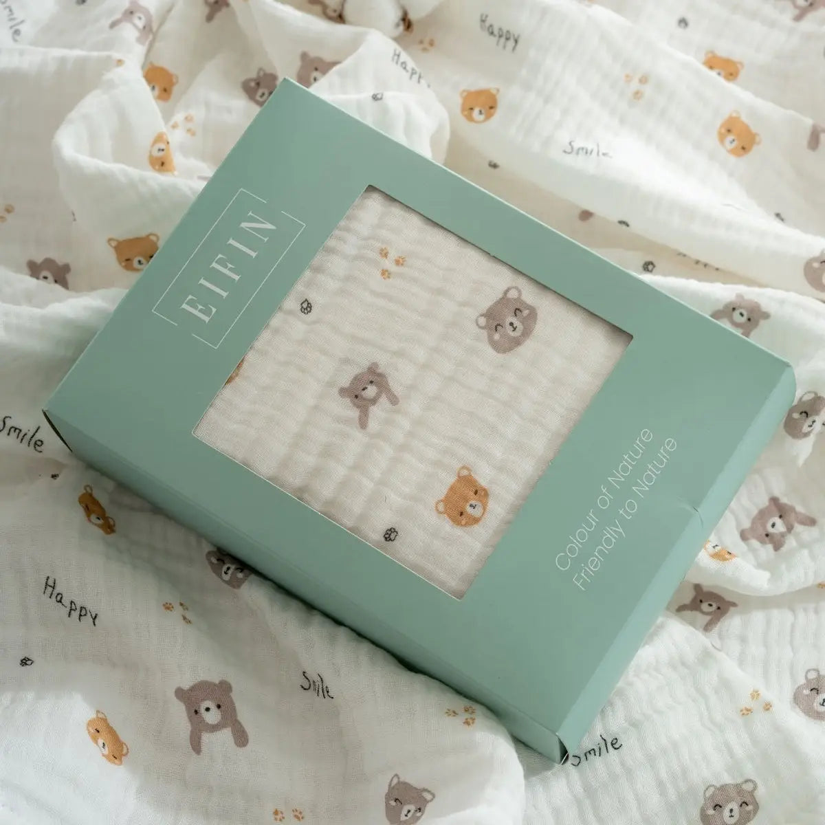 Muslin baby blanket gift boxed in a teal package with window, white teddy animal print