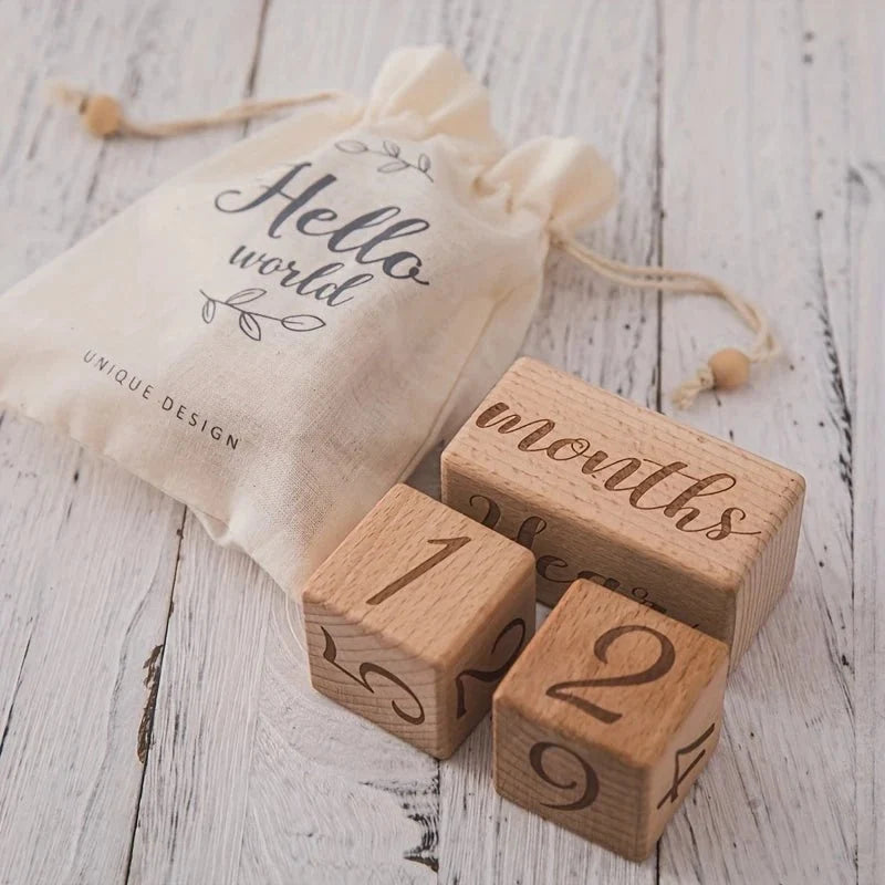 Wooden milestone blocks with number cubes 1 and 2 and 'months' text on base