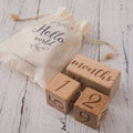 Wooden milestone blocks with number cubes 1 and 2 and 'months' text on base