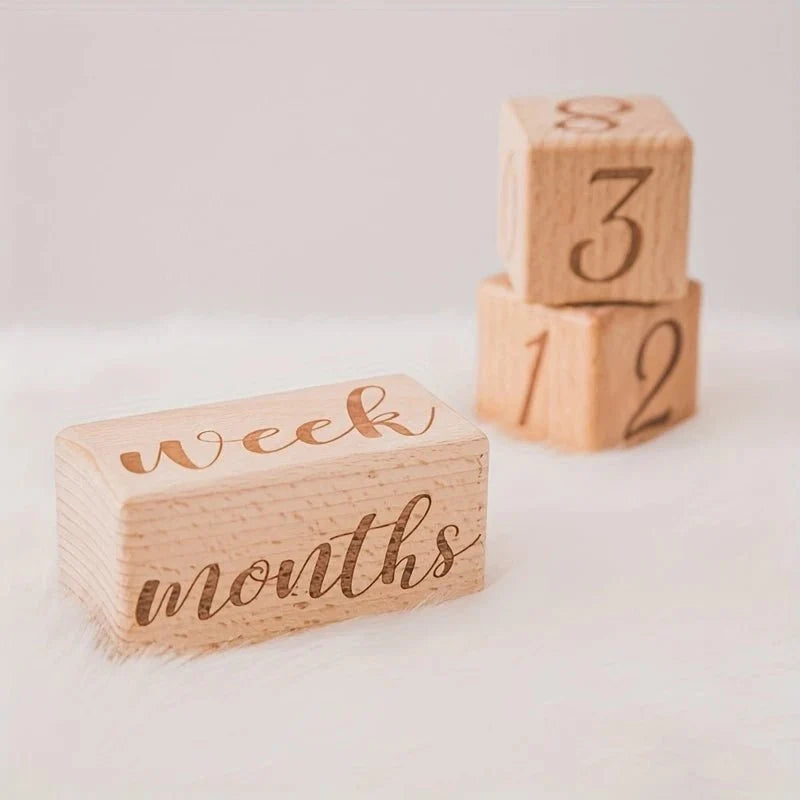 Wooden milestone blocks close-up with numbers 3 and 2 and 'weeks' text